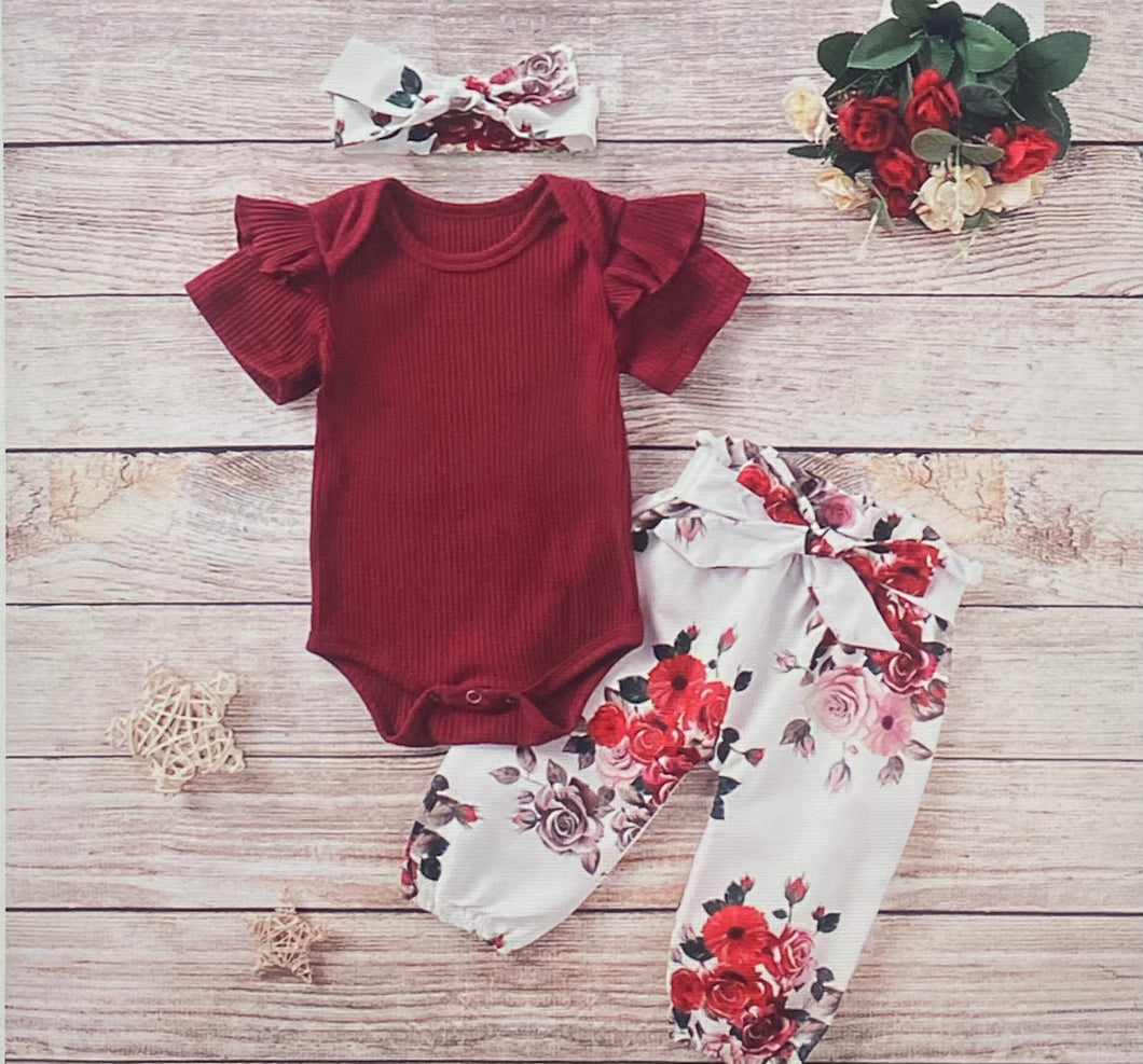 Long sleeve red onesie with floral pants and headband